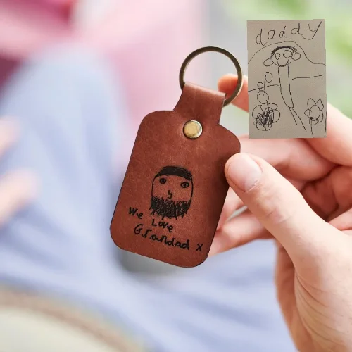 Travel bag with a built - in power bank charger for on - the - go device chargingLuxury Leather Key Ring with Childs Drawing