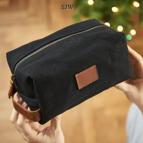 Soft - sided travel bag with reinforced corners for durabilityPersonalised Wash Bag - Canvas and Leather