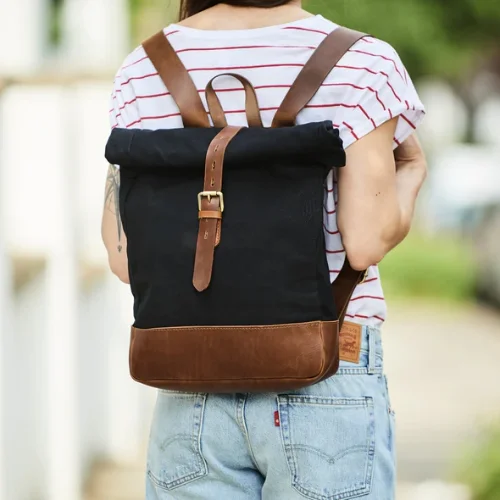 Anti - theft travel bag with RFID - blocking pockets for personal safetyRoll-top Canvas and Leather Backpack